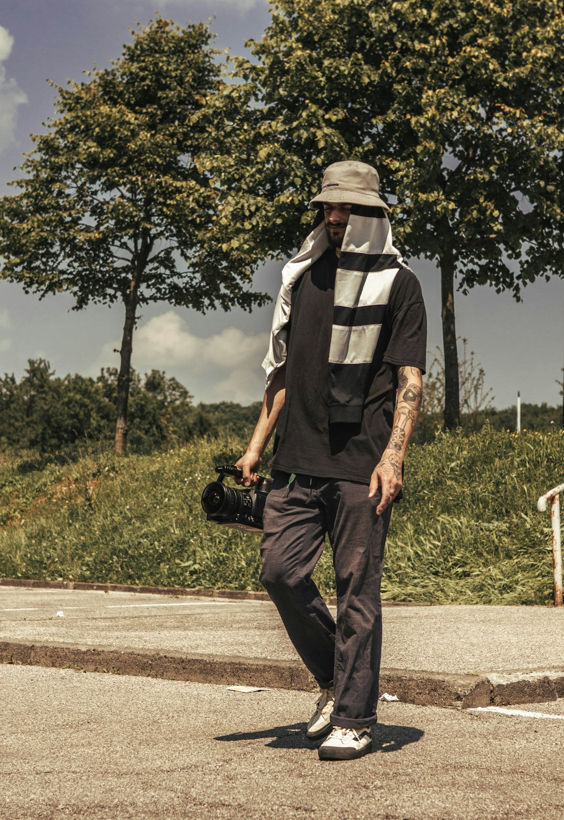 a man walking down a street with a hat on
