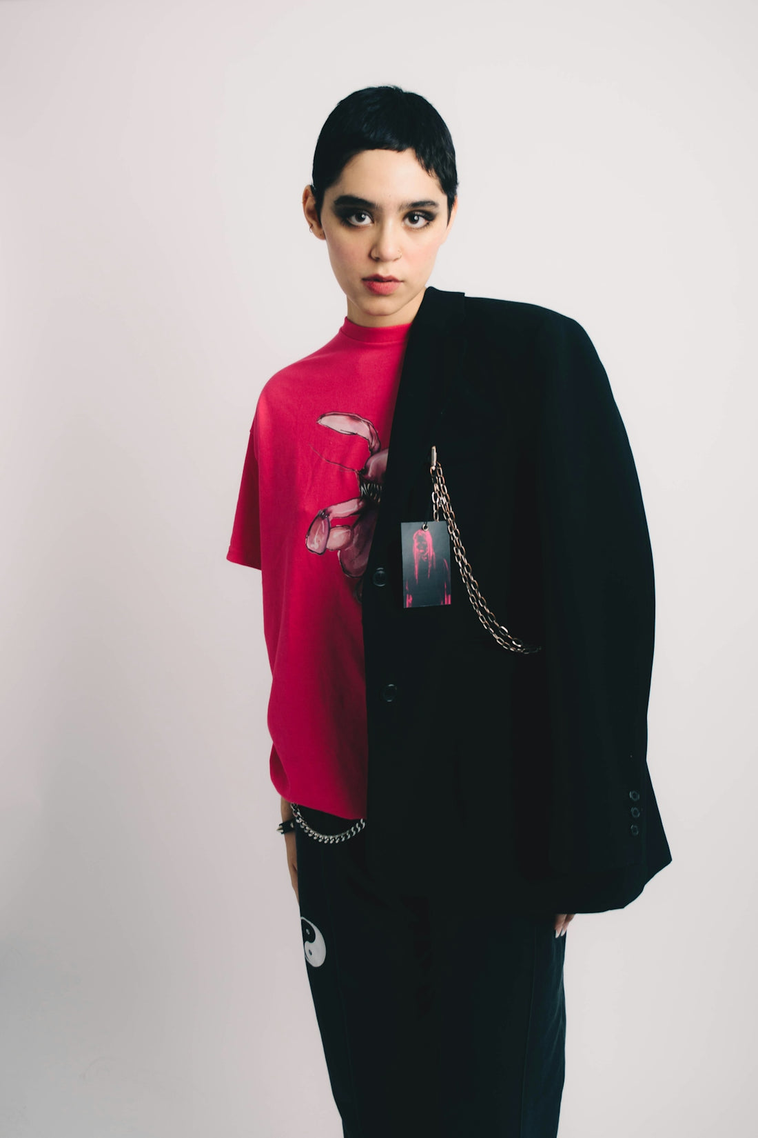 a woman wearing a red shirt and black pants