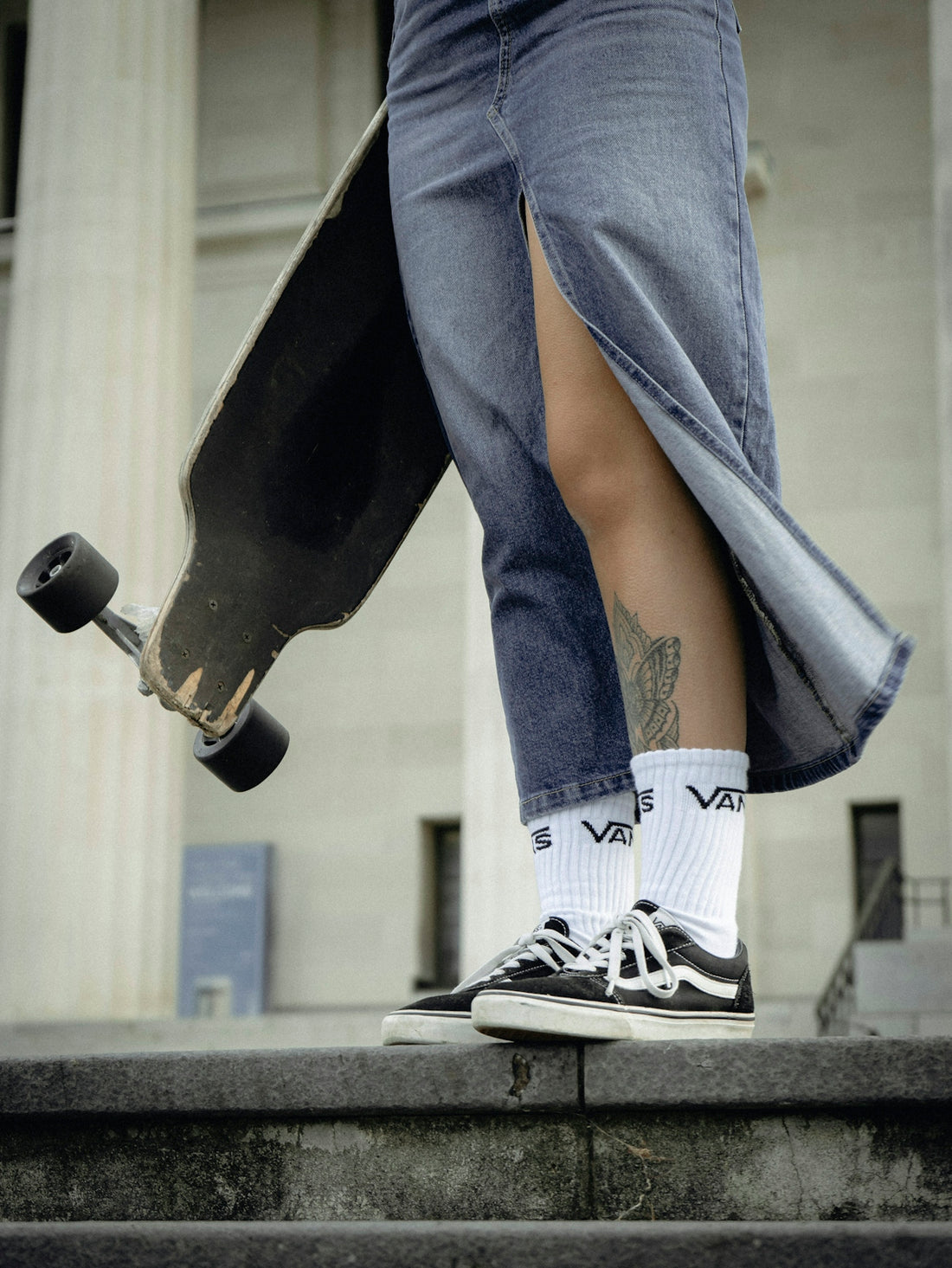 a person with a skateboard walking up some steps