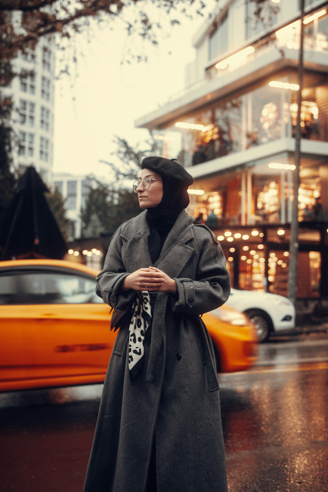 a woman standing on the side of the road