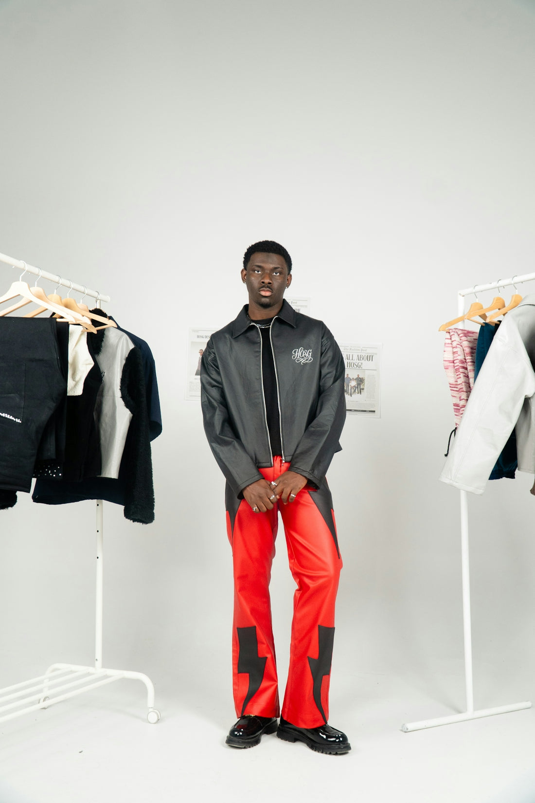 Young black man in stylish outfit with lightning pants.